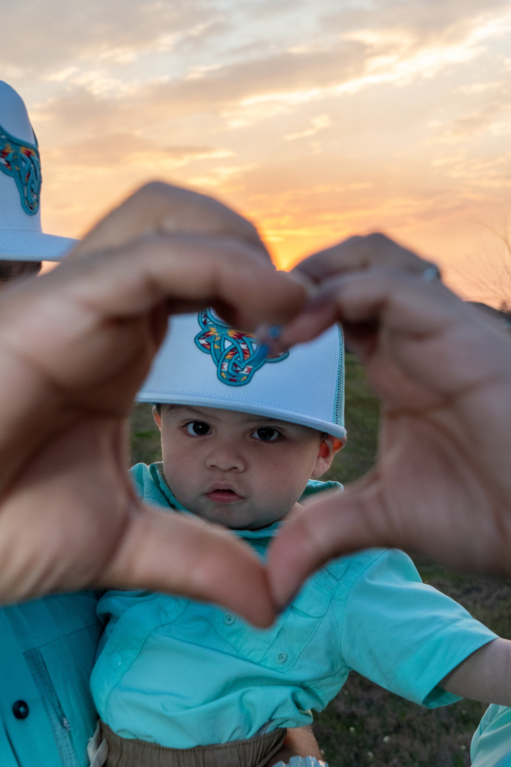 Heart hands with baby, family portrait detail