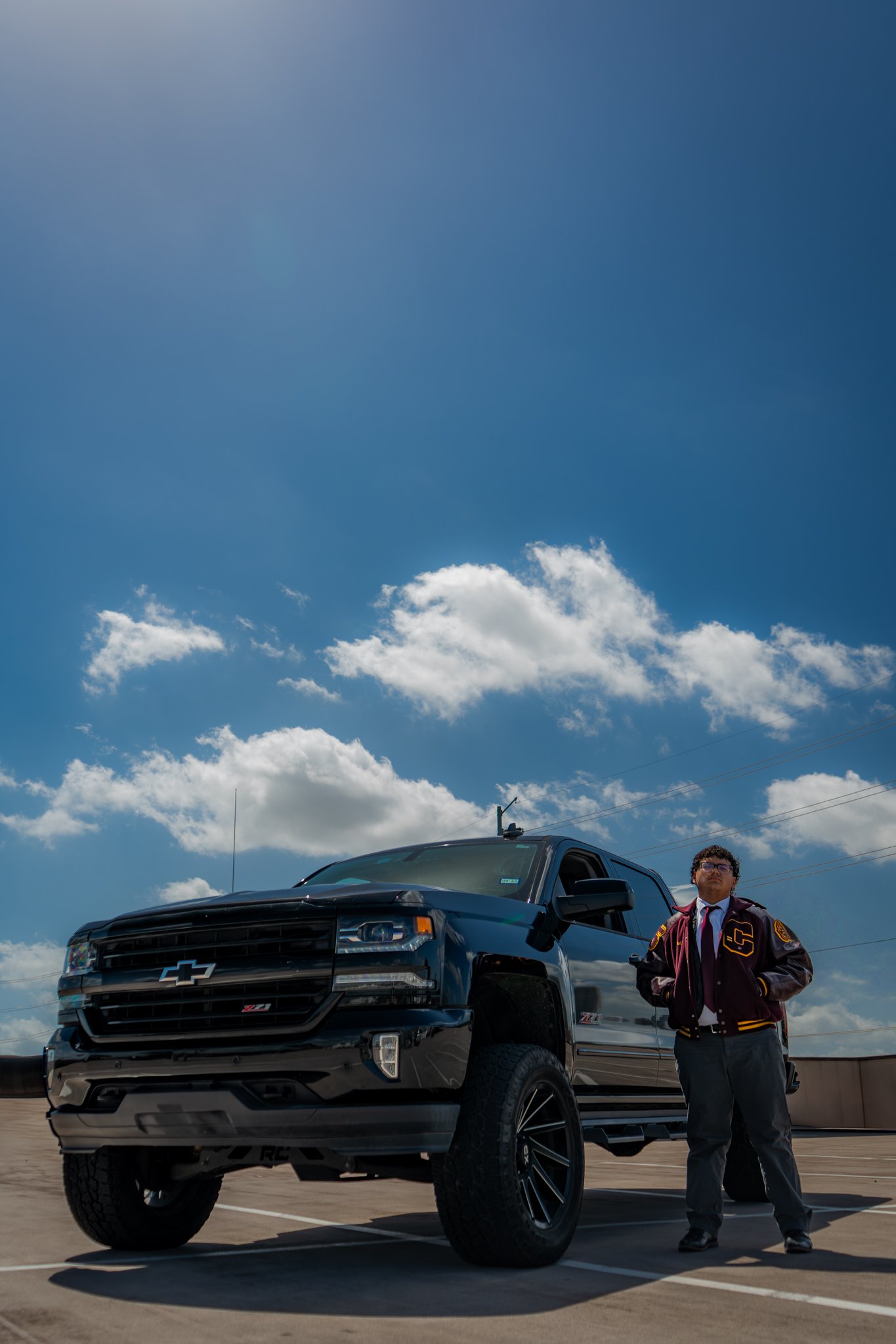 Graduate side profile on truck, red gown