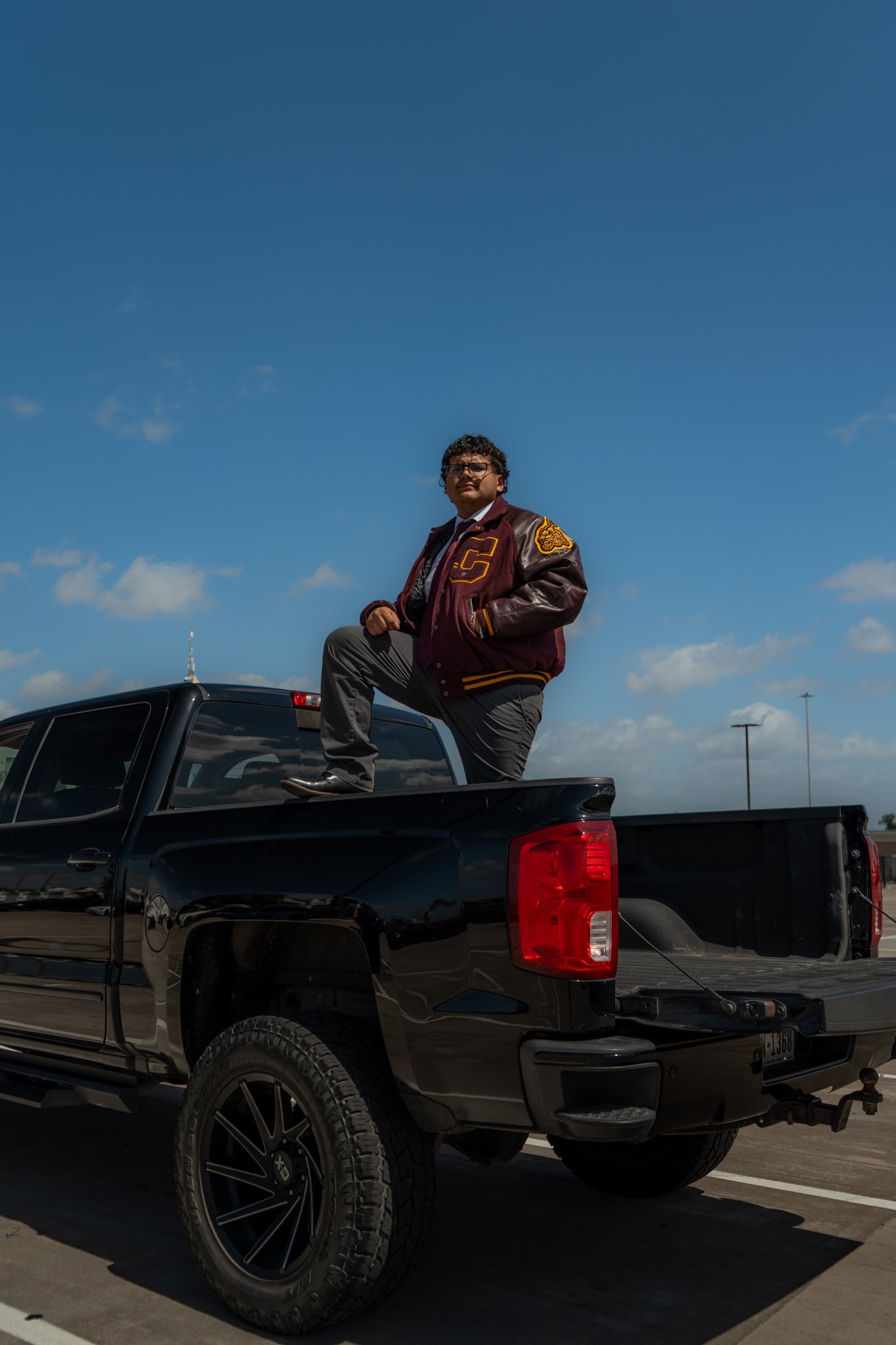 Graduate close portrait on truck, red gown