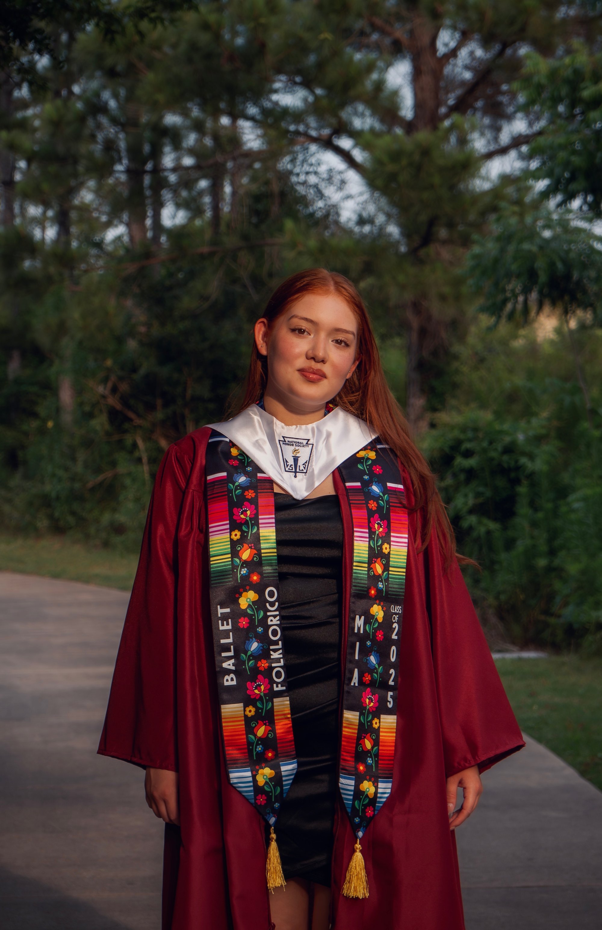 Graduate portrait with honor stole, maroon gown