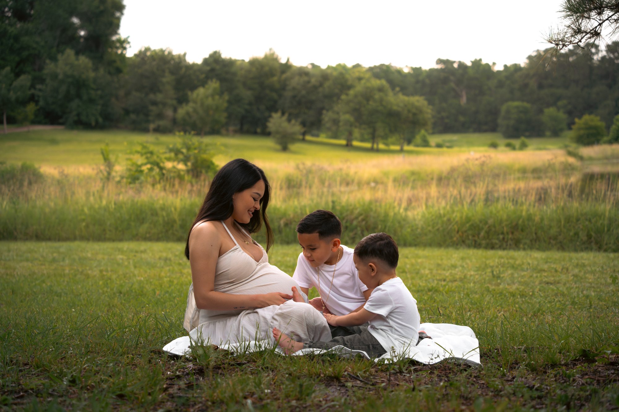 Maternity family portrait with two children in field