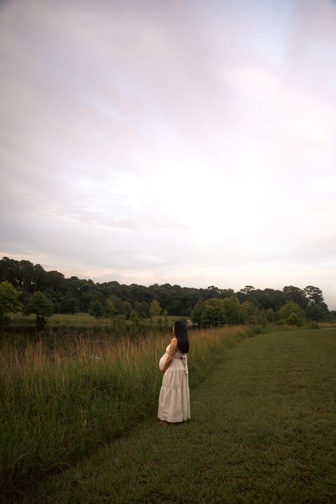 Maternity portrait walking through open field