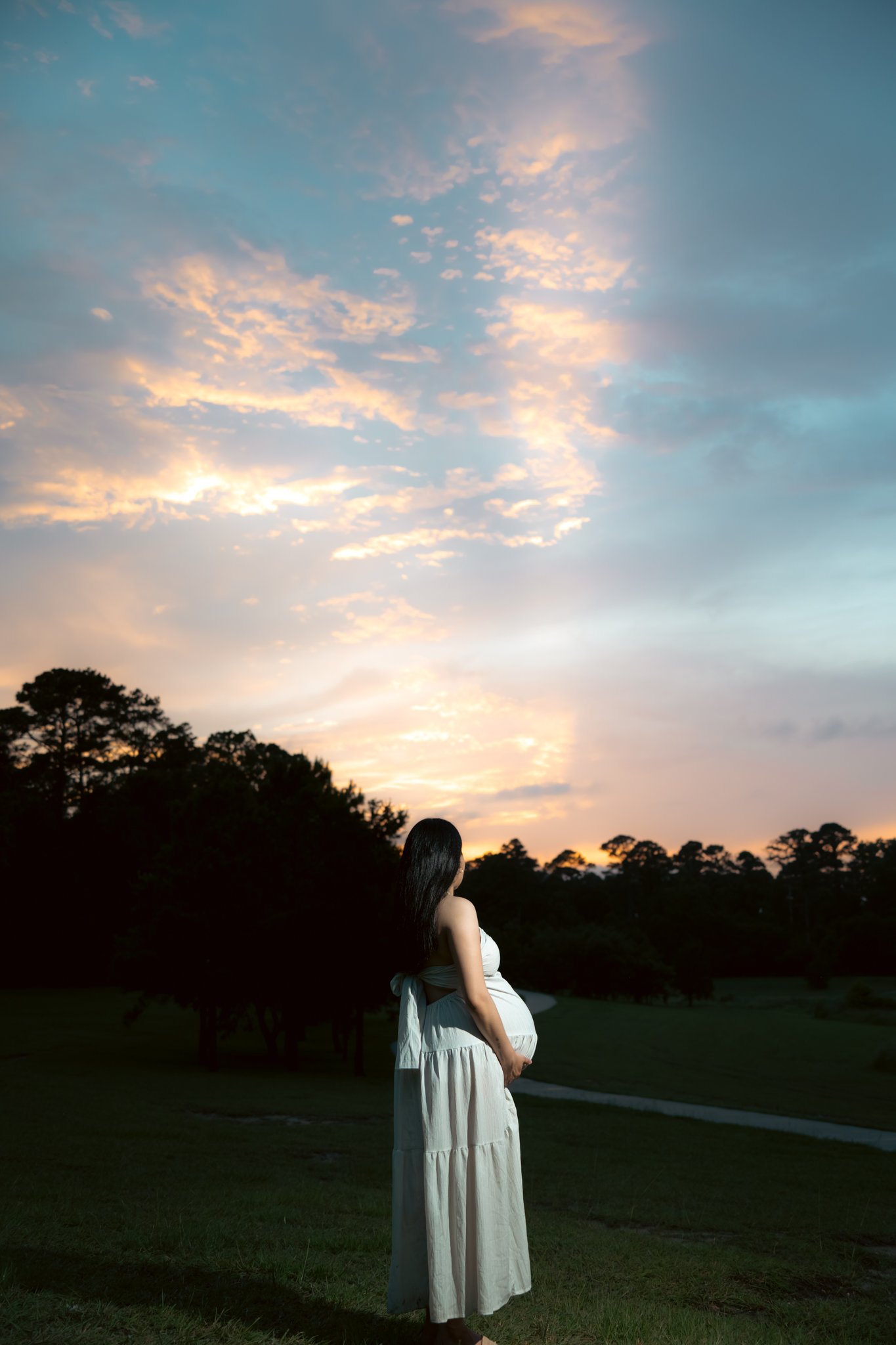 Maternity silhouette at sunset, wide shot